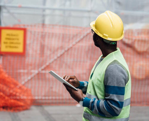 Portrait of a young African American engineer working at the construction site.